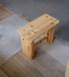 Ast Stool fra Vaarnii ved Kollekted by en interiørforretning i Oslo. Et heltre krakk sidebord designet av Dimiri Bähler. Utstilt på Nanimarquina Tres Vegtal teppe